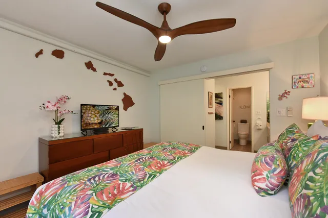 a bedroom with a bed and a dresser in it