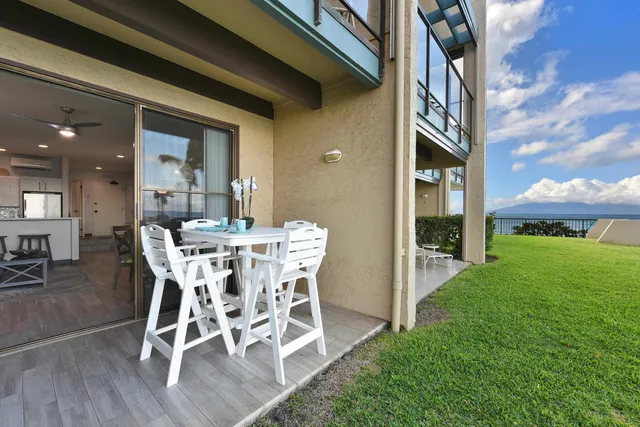 a view of a patio with table and chairs and potted plants