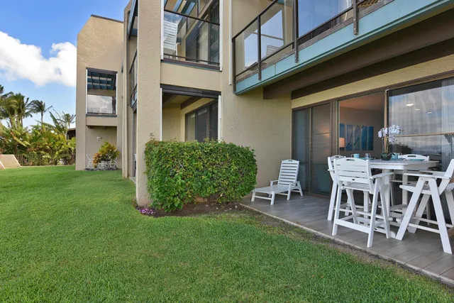 a view of a chairs and table in backyard of the house