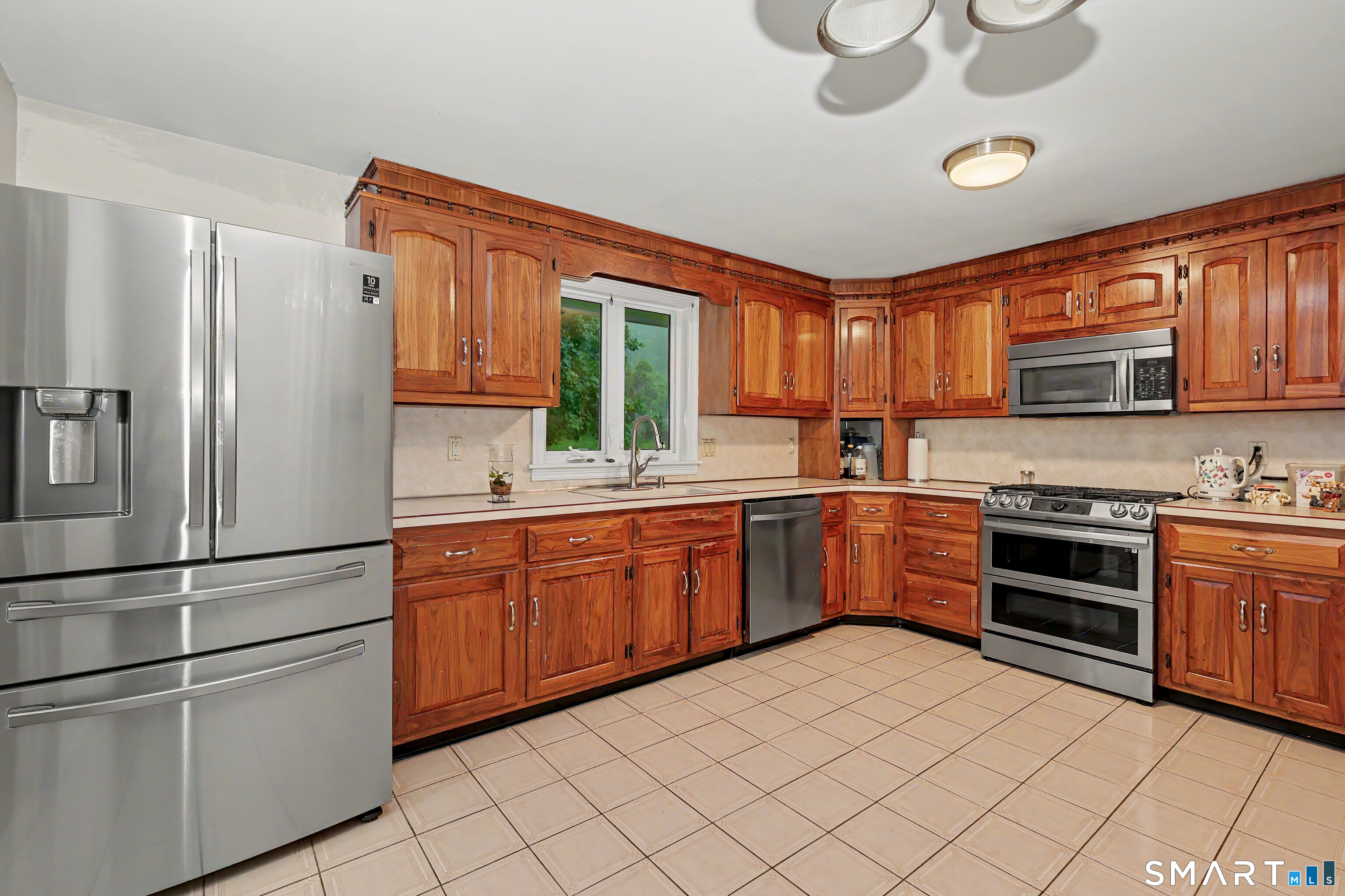 44 Haverhill Road Trumbull, CT 06611 - Photo 12 of 32 a kitchen with stainless steel appliances granite countertop a refrigerator sink and stove
