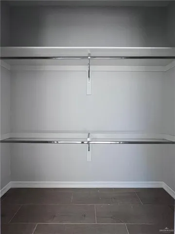 a view of a closet with wooden floor