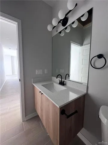 a bathroom with a sink a vanity and a mirror