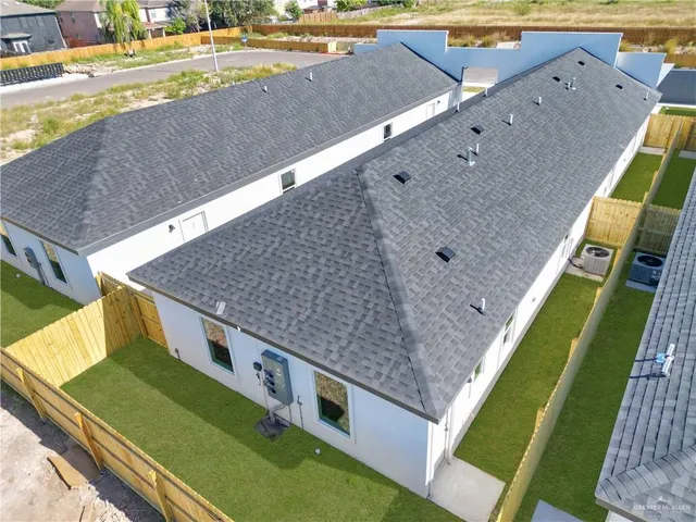 a view of a backyard with lawn chairs