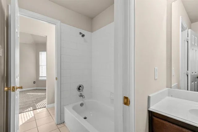 a bathroom with a bathtub and a sink