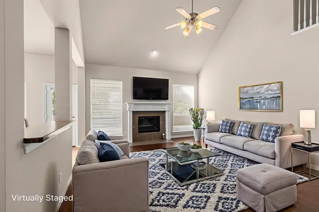 a living room with furniture a fireplace and a flat screen tv
