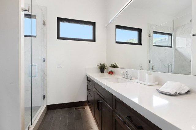 11547 Soaring Hawk Lane Hideout, UT 84036 - Photo 16 of 43 Contemporary bathroom featuring a dark wood-finish vanity with a white countertop and integrated sink