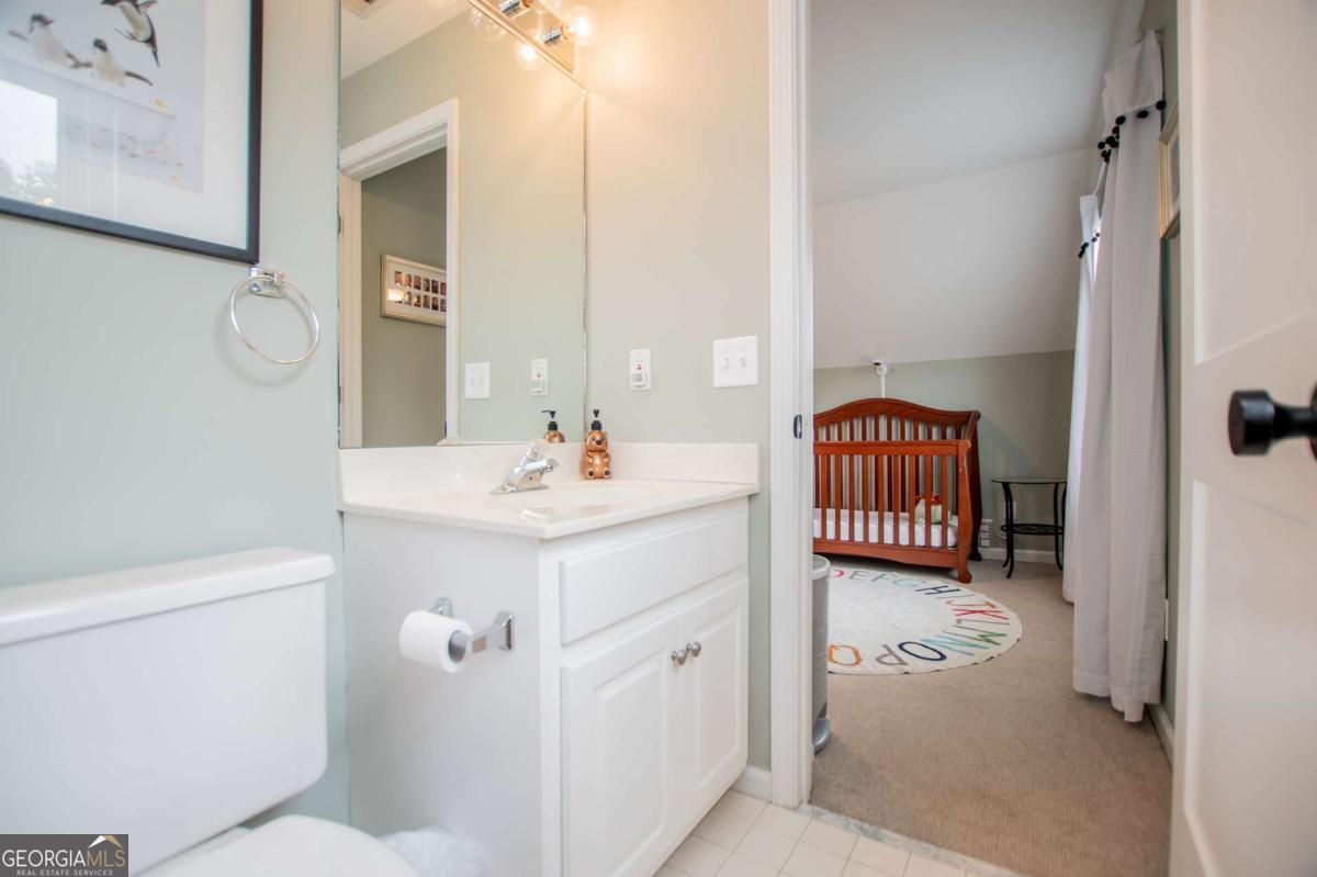 1745 Stripling Chapel Road Carrollton, GA 30116 - Photo 29 of 87 a bathroom with a sink and mirror with toilet