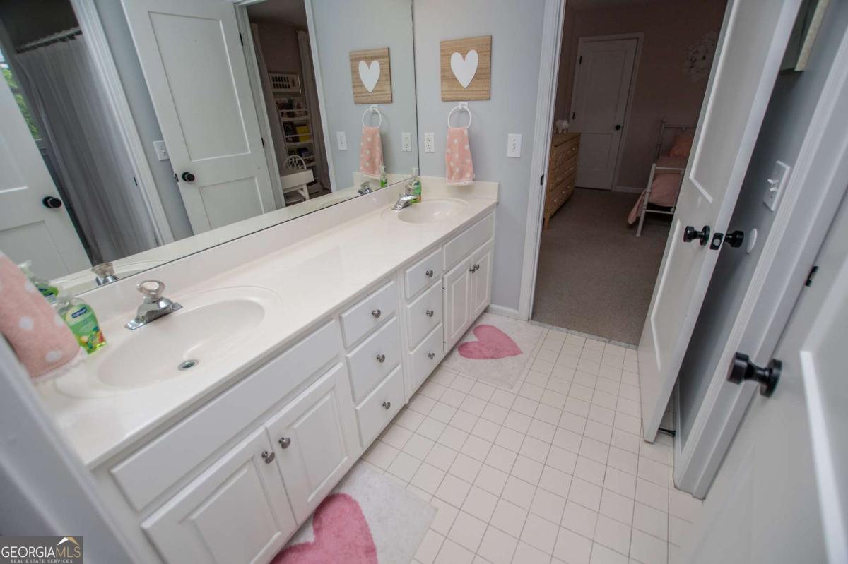 1745 Stripling Chapel Road Carrollton, GA 30116 - Photo 31 of 87 a bathroom with a double vanity sink mirror and shower