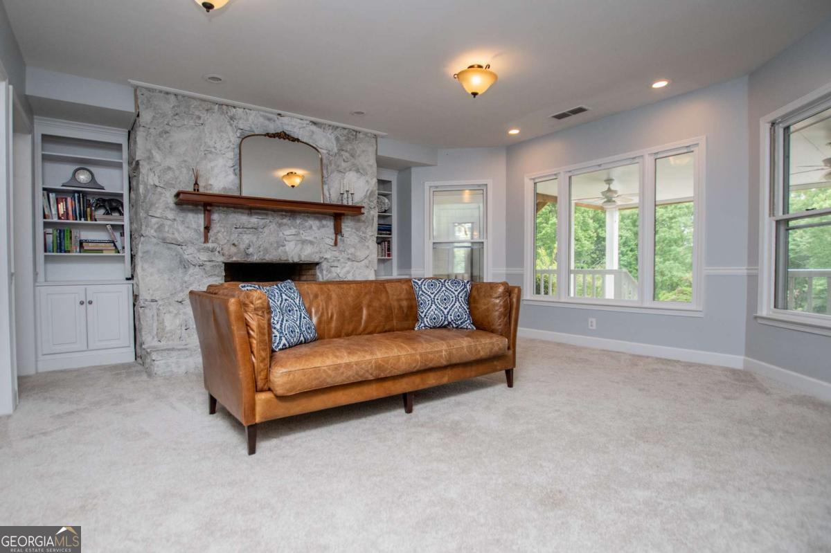 1745 Stripling Chapel Road Carrollton, GA 30116 - Photo 41 of 87 a living room with furniture and a fireplace