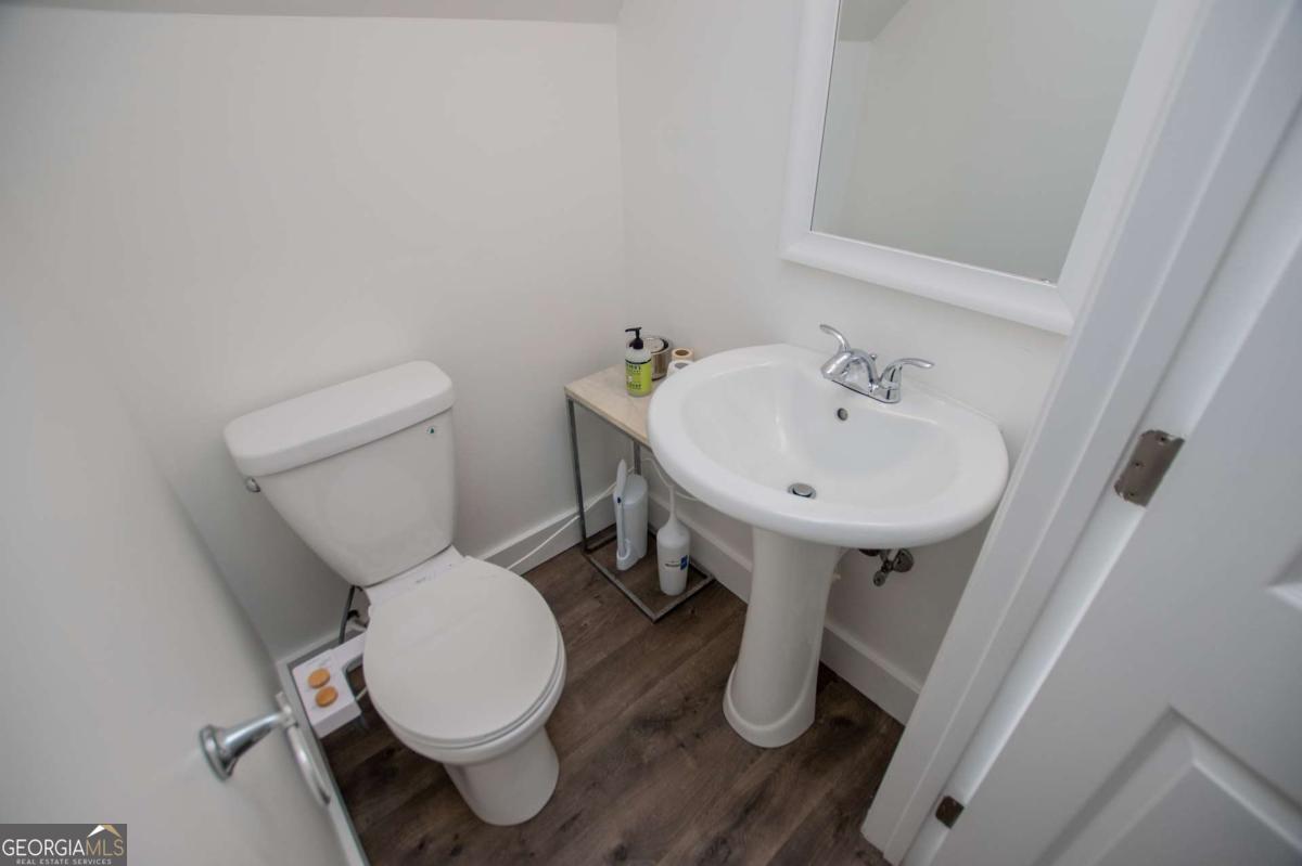 1745 Stripling Chapel Road Carrollton, GA 30116 - Photo 47 of 87 a bathroom with a toilet sink and mirror