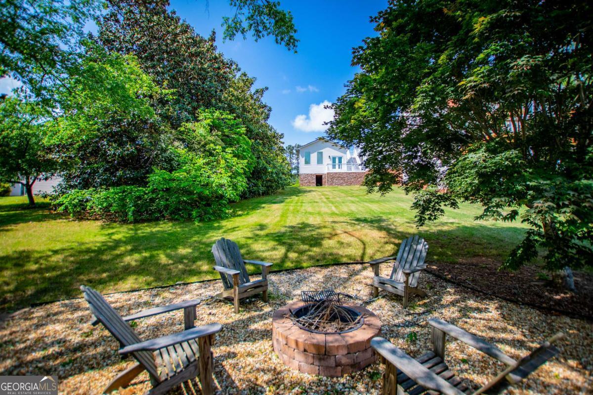 1745 Stripling Chapel Road Carrollton, GA 30116 - Photo 71 of 87 a view of a backyard with plants and a patio