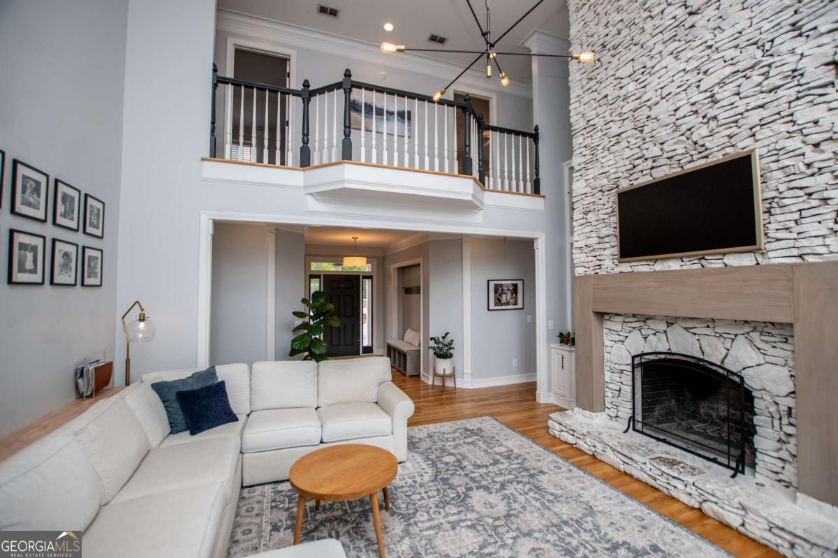 1745 Stripling Chapel Road Carrollton, GA 30116 - Photo 9 of 87 a living room with furniture a flat screen tv and a fireplace