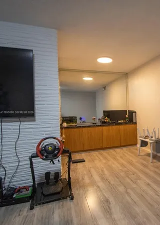 a view of kitchen with furniture and wooden floor