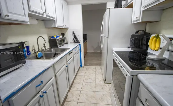 a kitchen with stainless steel appliances granite countertop a sink and a stove