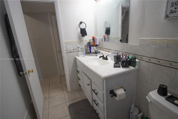 a bathroom with a sink vanity and toilet