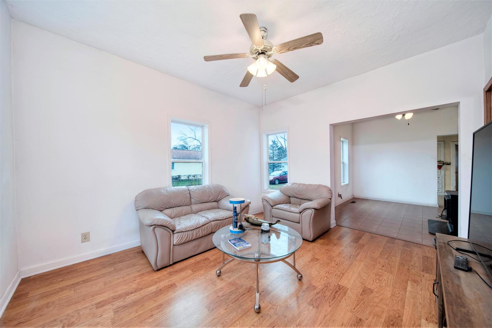 11611 Maple Avenue Hebron, IL 60034 - Photo 6 of 17 a living room with furniture a large window and a chandelier