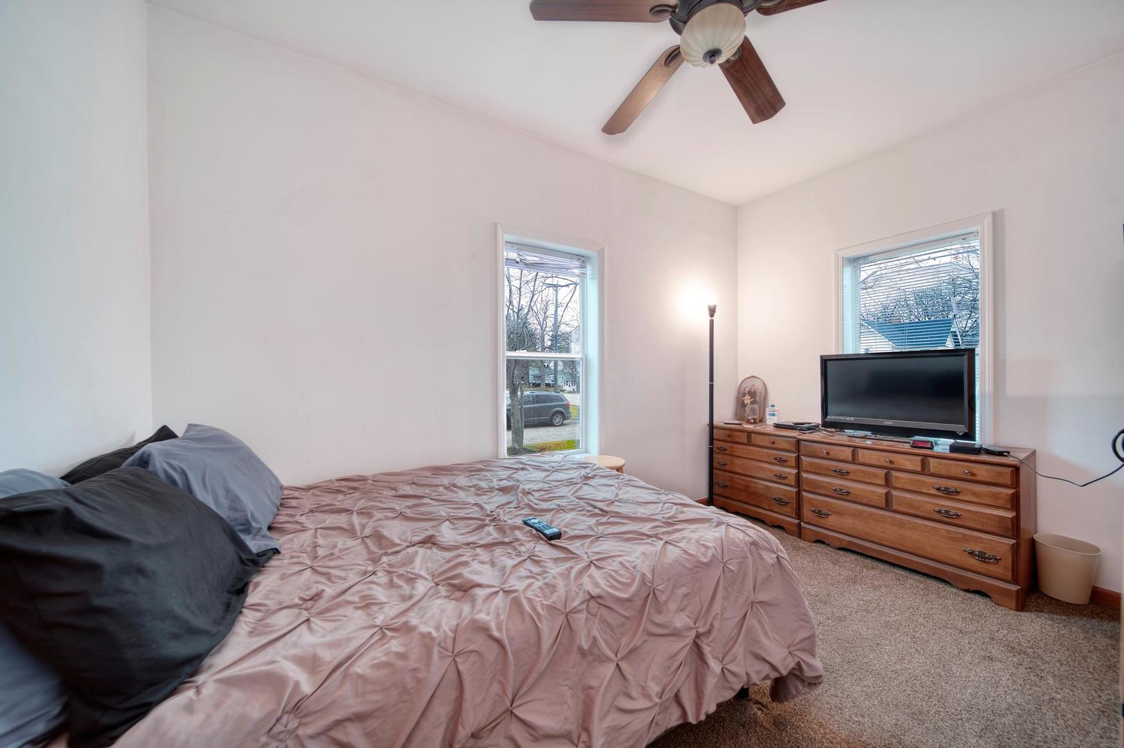 11611 Maple Avenue Hebron, IL 60034 - Photo 8 of 17 a bedroom with a bed and a flat screen tv