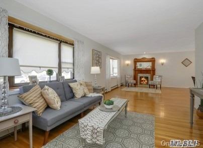 1269 Raymond Road Bellmore, NY 11710 - Photo 1 of 1 a living room with furniture and a table