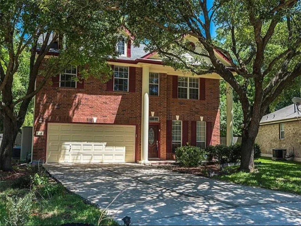 16303 Ascent Cove Pflugerville, TX 78660 - Photo 2 of 37 a front view of a house with a yard and garage