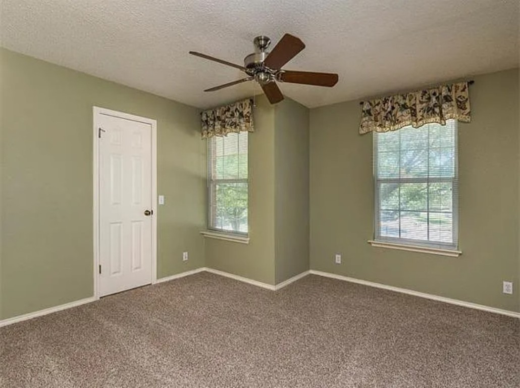 16303 Ascent Cove Pflugerville, TX 78660 - Photo 21 of 37 a view of a livingroom with a ceiling fan & windows