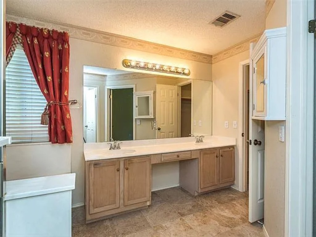 16303 Ascent Cove Pflugerville, TX 78660 - Photo 23 of 37 a bathroom with a double vanity sink mirror and