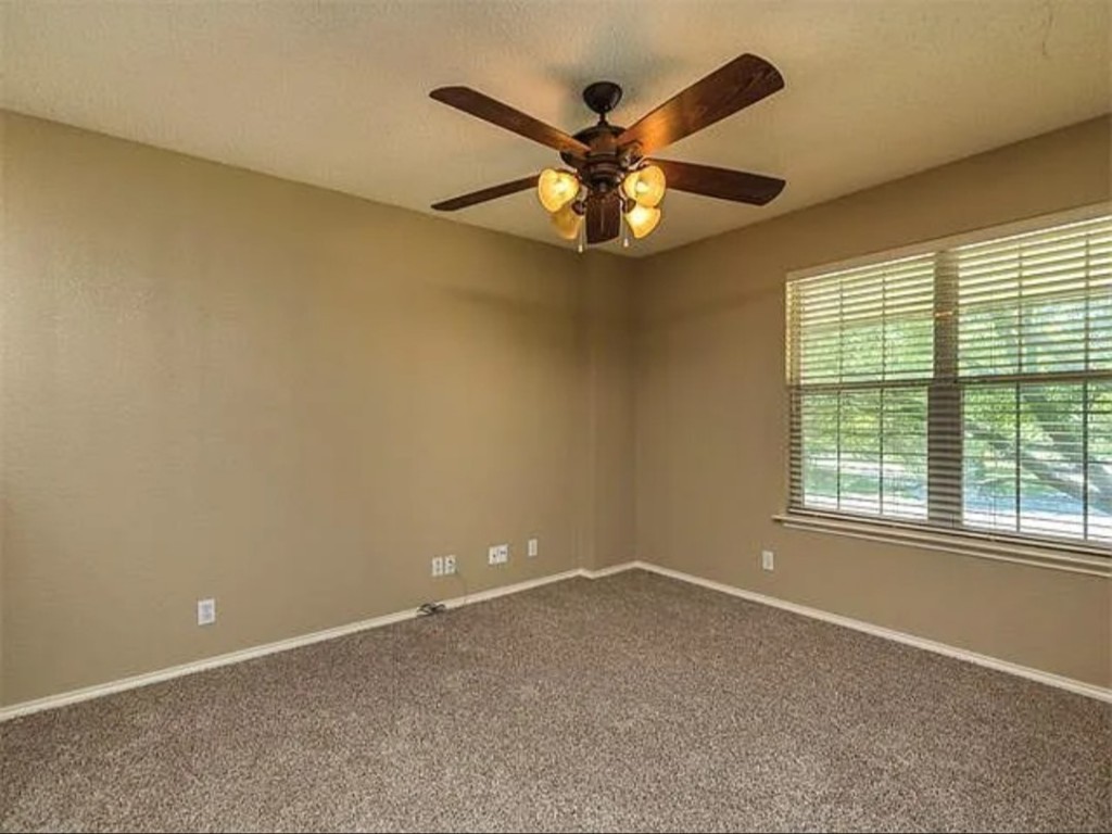 16303 Ascent Cove Pflugerville, TX 78660 - Photo 27 of 37 an empty room with a window and a fan