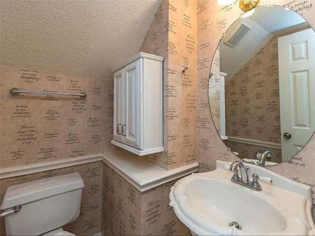16303 Ascent Cove Pflugerville, TX 78660 - Photo 29 of 37 a bathroom with a sink and a mirror