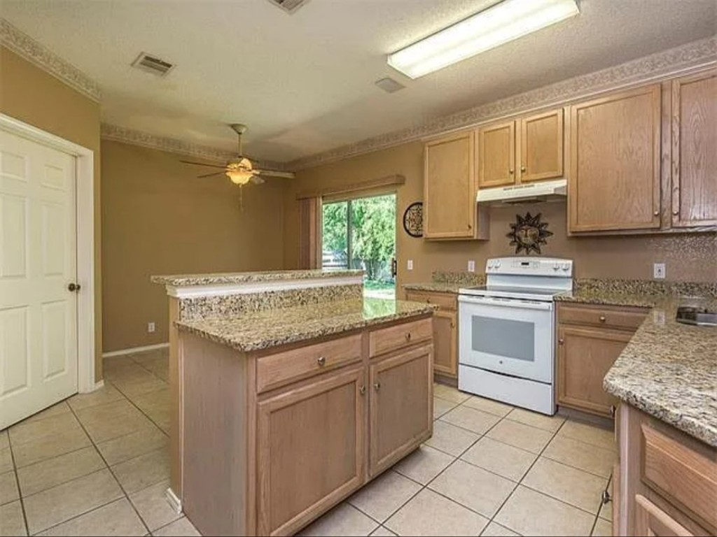 16303 Ascent Cove Pflugerville, TX 78660 - Photo 32 of 37 a kitchen with granite countertop a sink stainless steel appliances and cabinets
