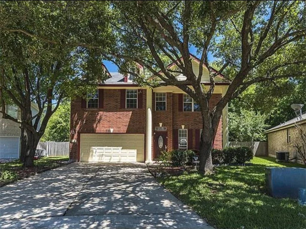 16303 Ascent Cove Pflugerville, TX 78660 - Photo 4 of 37 a front view of a house with a garden and tree