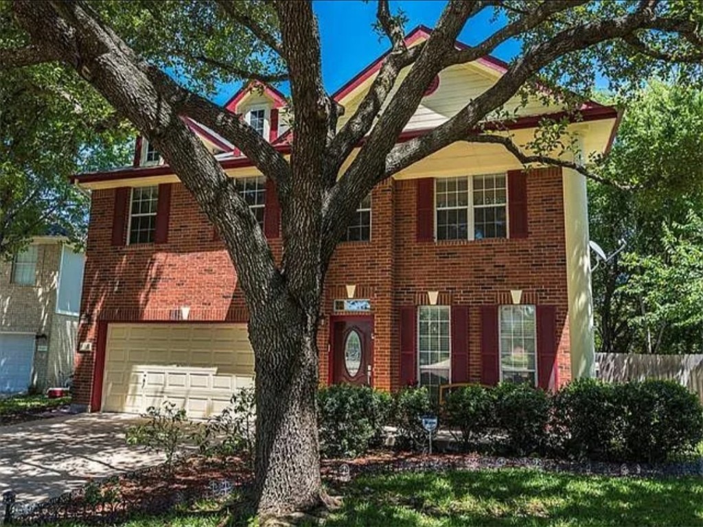 16303 Ascent Cove Pflugerville, TX 78660 - Photo 5 of 37 a front view of a house with a tree
