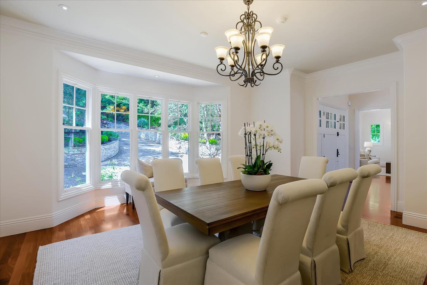 700 Patrol Road Woodside, CA 94062 - Photo 15 of 55 a view of a dining room with furniture a chandelier and wooden floor