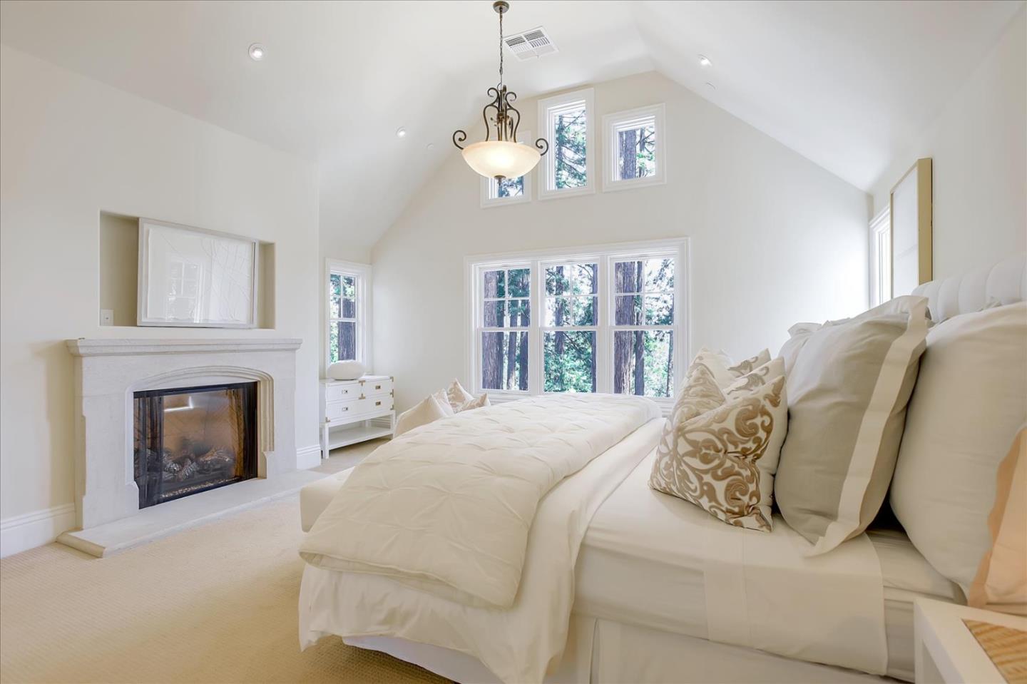700 Patrol Road Woodside, CA 94062 - Photo 24 of 55 a spacious bedroom with a bed and a fireplace