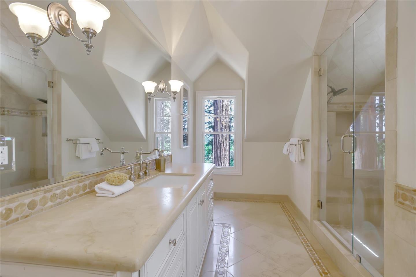 700 Patrol Road Woodside, CA 94062 - Photo 28 of 55 a spacious bathroom with a granite countertop sink a mirror a vanity and a shower