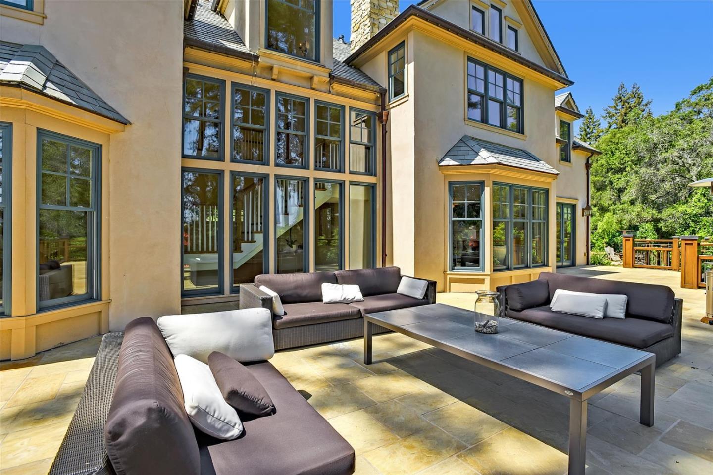 700 Patrol Road Woodside, CA 94062 - Photo 45 of 55 a view of a patio with couches table and chairs and potted plants