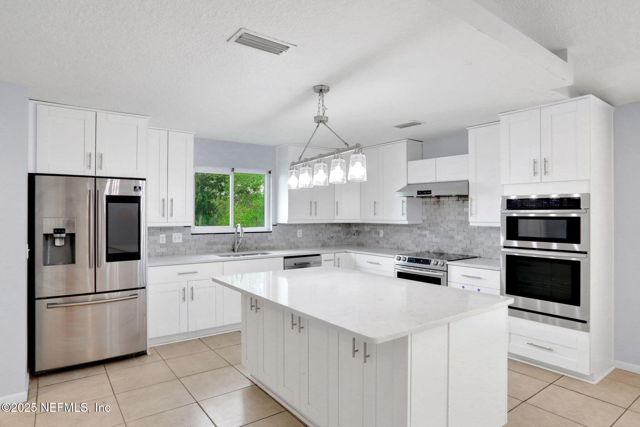 12228 Smoke Ridge Circle South Jacksonville, FL 32225 - Photo 11 of 50 a kitchen with appliances a sink and cabinets