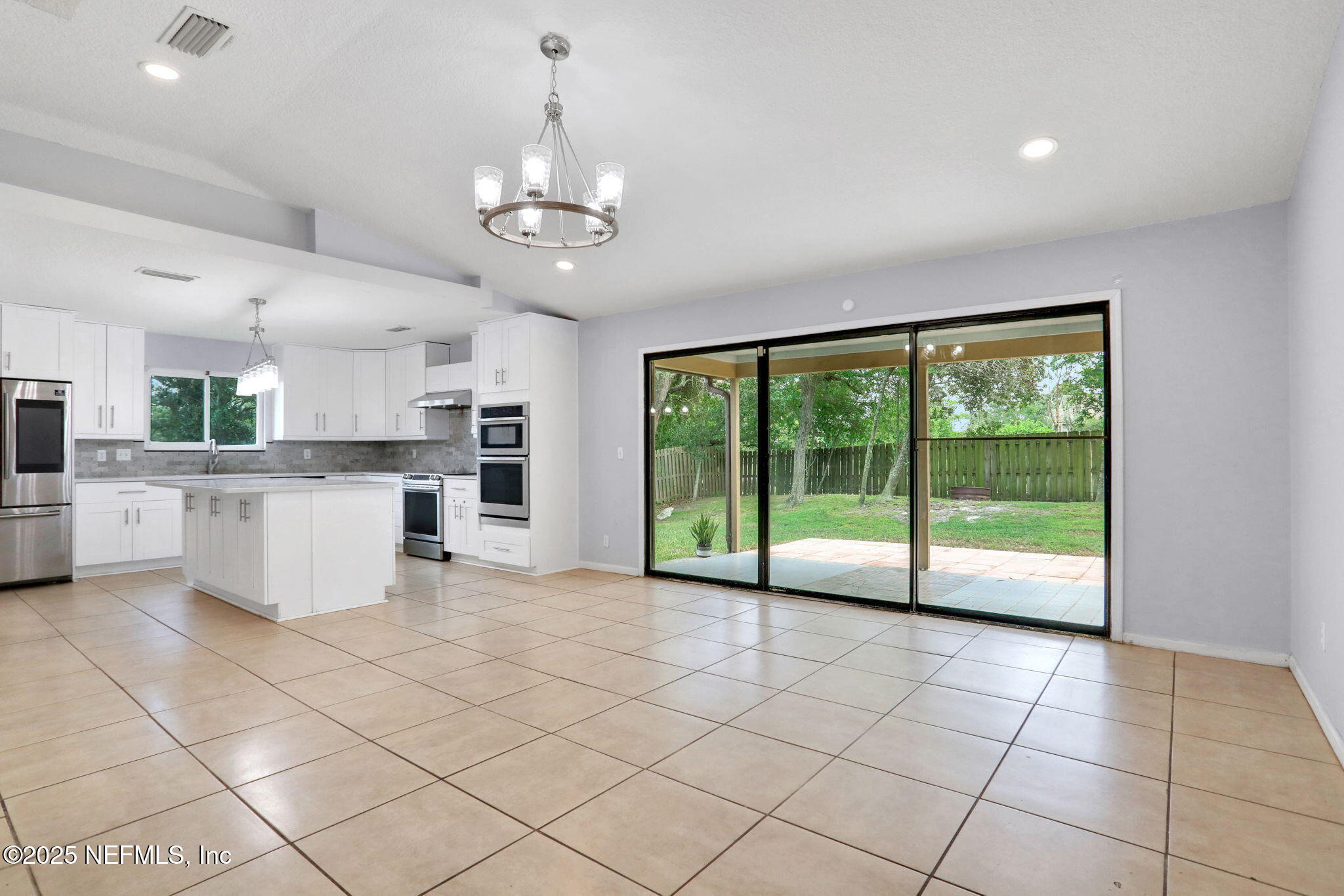 12228 Smoke Ridge Circle South Jacksonville, FL 32225 - Photo 12 of 50 a view of a kitchen with furniture an empty space and a window