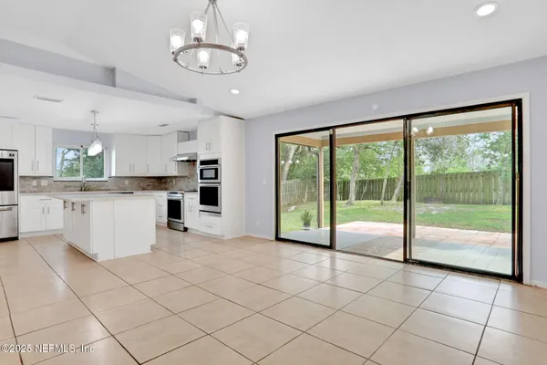 a view of a kitchen with microwave and floor to ceiling window