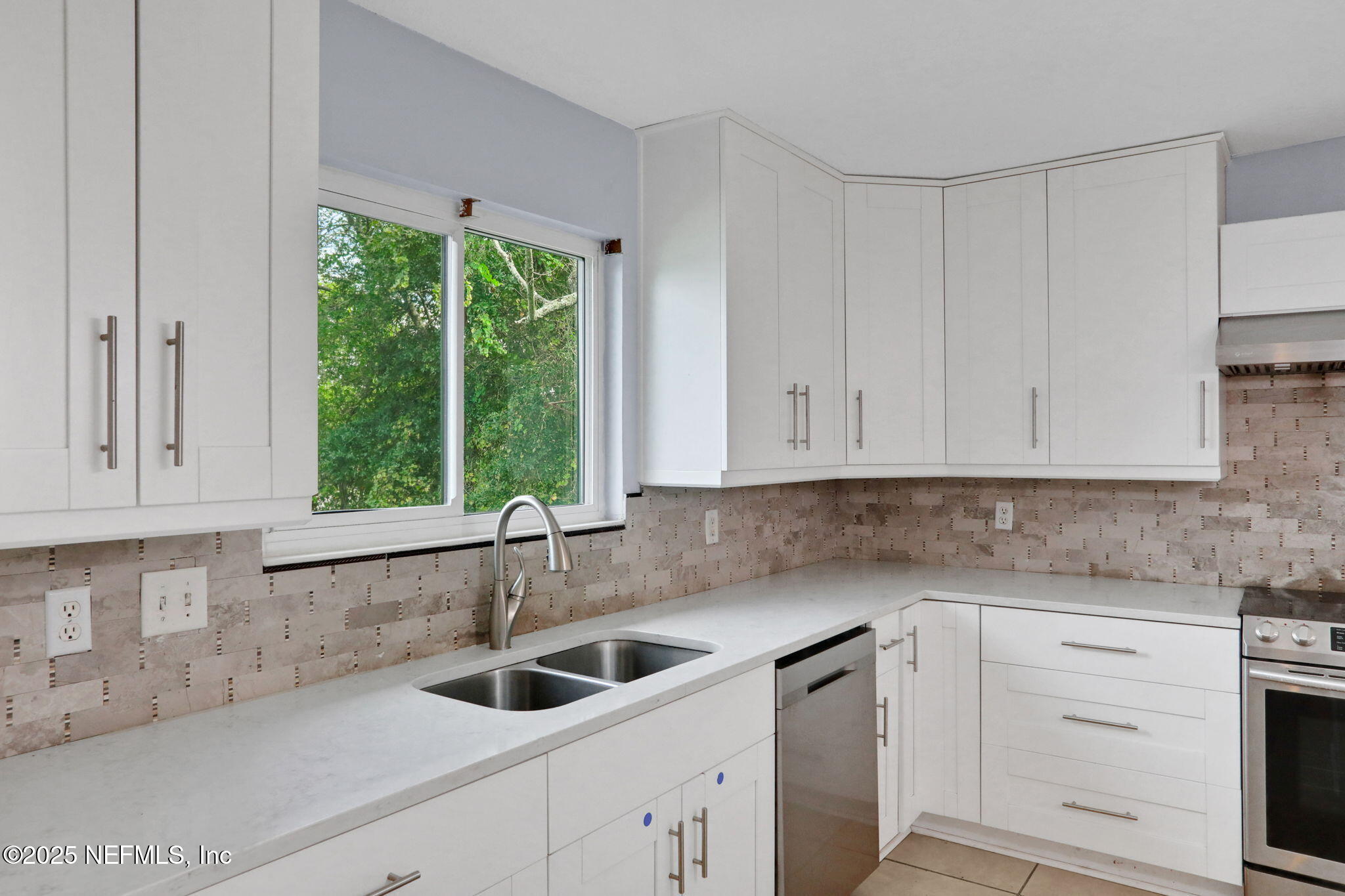 12228 Smoke Ridge Circle South Jacksonville, FL 32225 - Photo 15 of 50 a kitchen with granite countertop white cabinets and a sink