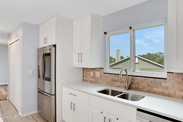 a kitchen with a refrigerator and a sink