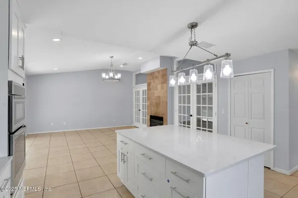 a view of a kitchen cabinets and chandelier