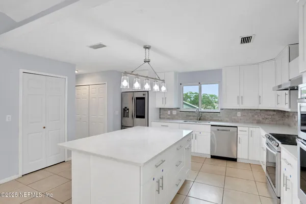 a kitchen with a sink stove and refrigerator