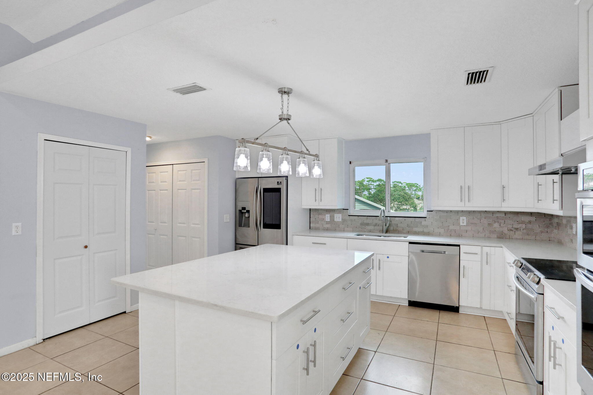 12228 Smoke Ridge Circle South Jacksonville, FL 32225 - Photo 19 of 50 a kitchen with a sink stove and refrigerator