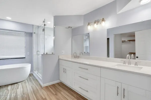 a bathroom with a double vanity sink mirror and double