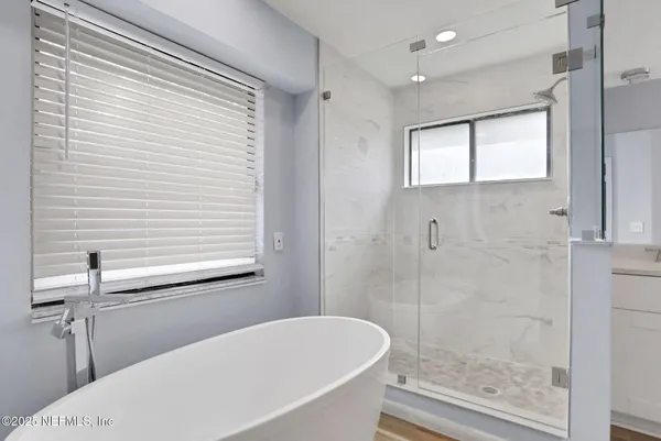 a bathroom with a bathtub and a shower