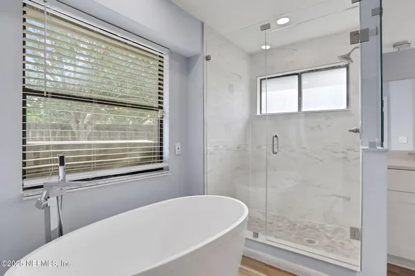 a bathroom with a bathtub and a shower