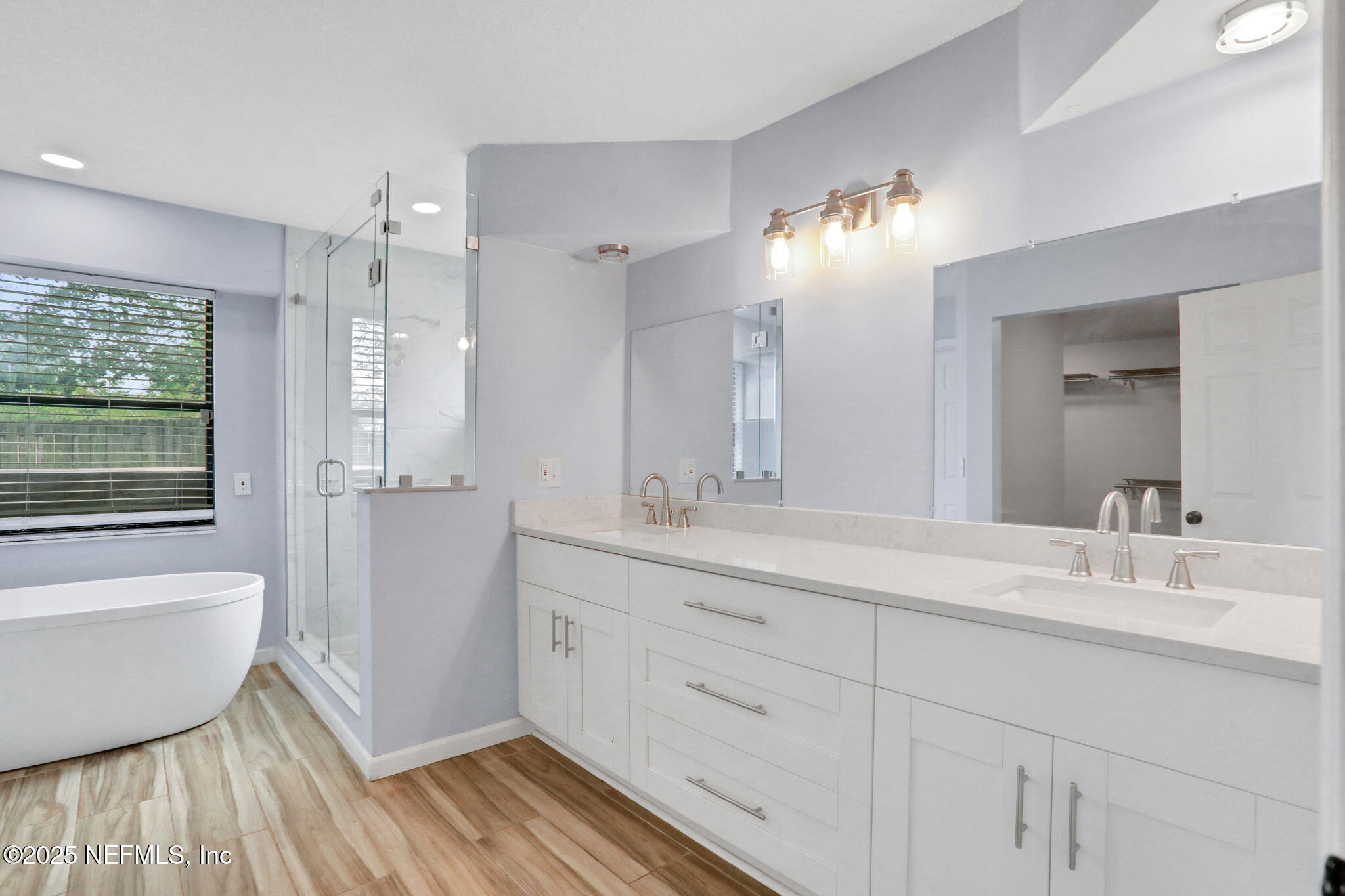 12228 Smoke Ridge Circle South Jacksonville, FL 32225 - Photo 32 of 50 a bathroom with a double vanity sink a mirror and a shower