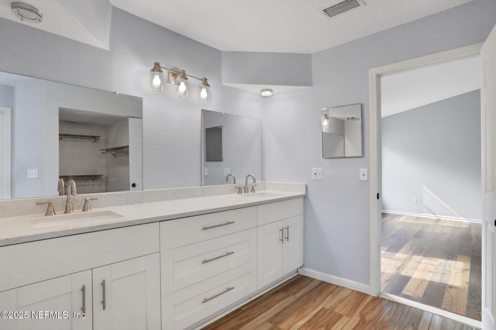 12228 Smoke Ridge Circle South Jacksonville, FL 32225 - Photo 33 of 50 a bathroom with a double vanity sink and a mirror