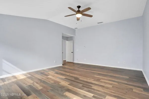 a view of a room with a ceiling fan