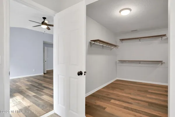 a view of a big room with closet and wooden floor