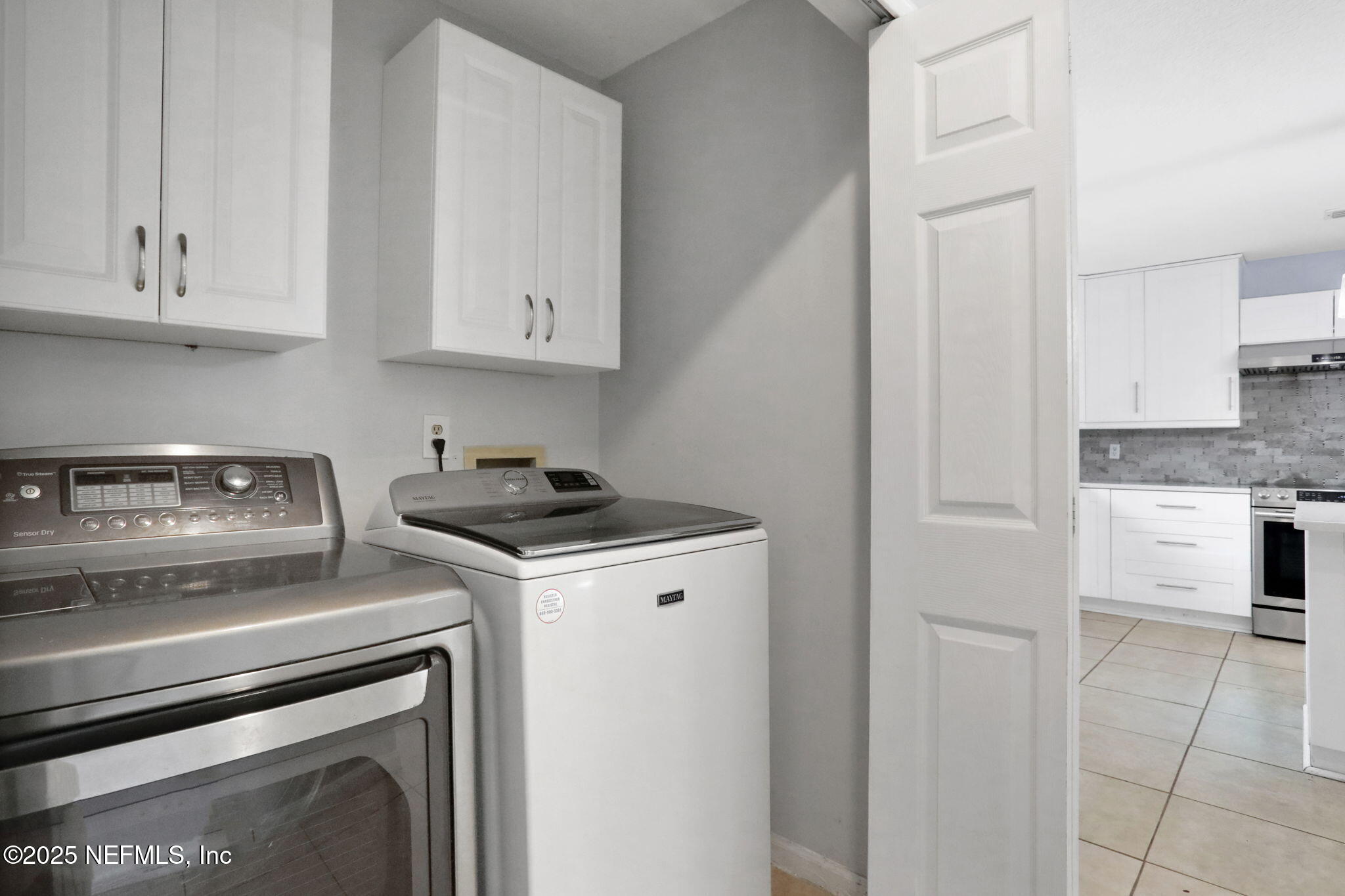 12228 Smoke Ridge Circle South Jacksonville, FL 32225 - Photo 43 of 50 a kitchen with a stove and white cabinets